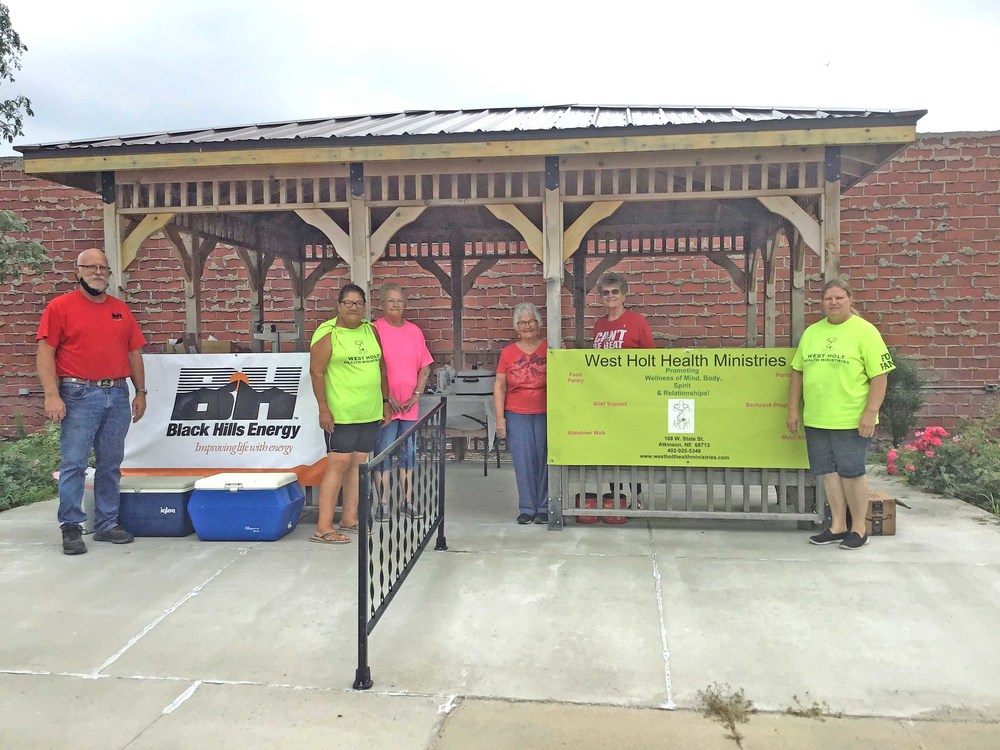 Can Care-A-Van helpers at the gazebo.