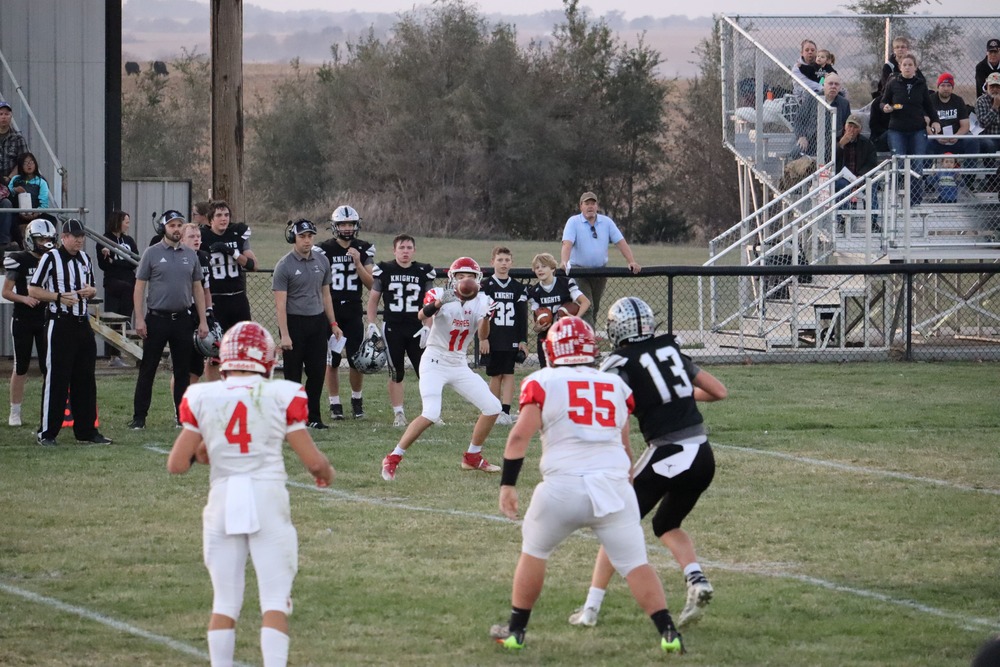Pirate quarterback Tanner Frahm and Xander Albin watch for completion of a pass to Rece Frahm during the E-M game