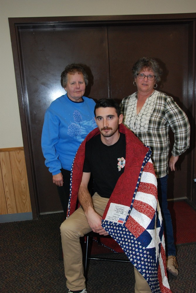 Austin Pittet of Brunswick with his Quilt of Valor, presented by Linda Wahrer, Auxiliary President and Janet Todd, Vice-President. Photo by Sandy Schroth.