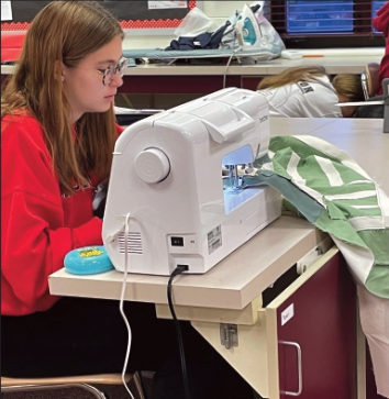 Piper Dather sewing her quilt to get to the next step.