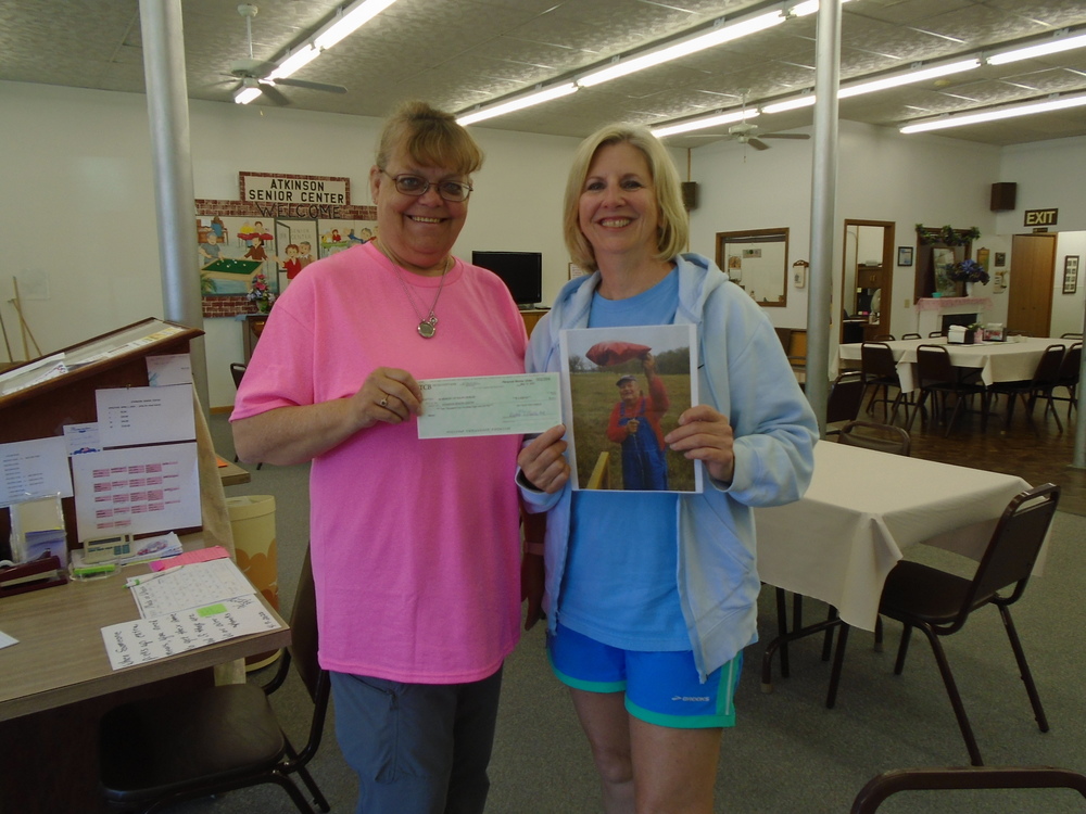 Atkinson Senior Center Manager Cathy Minchow accepts a check from Diane Tasler who is the power of attorney for the Ralph Deibler estate. Photo by Lorraine Lieswald