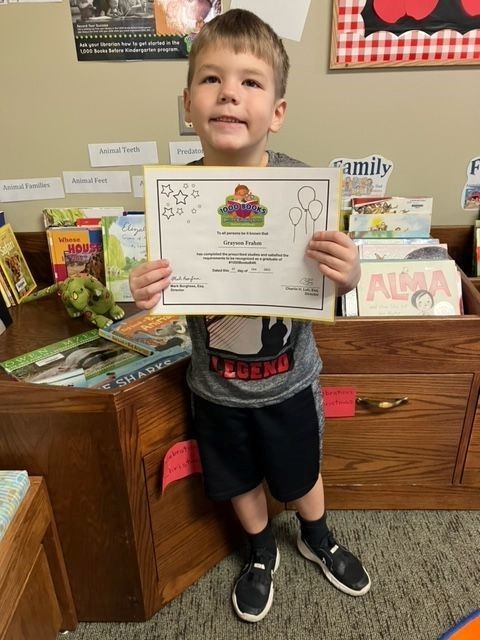 Grayson Frahm with his award at the Plainview Library.