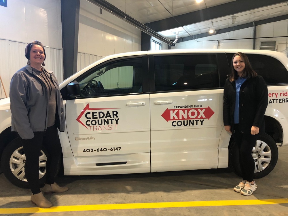 Manager Nikki Pinkelman and Scheduler Ashley Gowery with one of the 14 Cedar County Transit vans