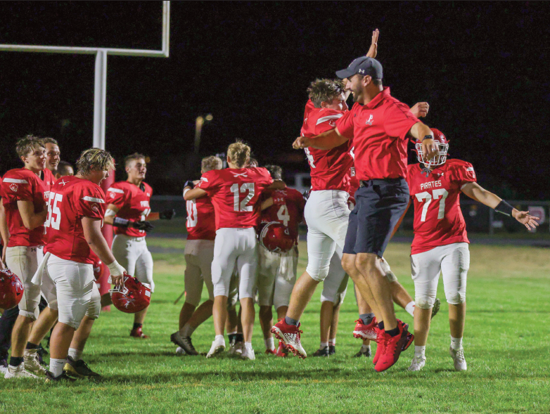 Coach Kyle Schmidt celebrates with his team after the win over Wakefield.