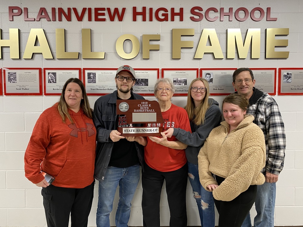 Family members of Plainview Schools basketball team member Ed Lerum with the 1919 State Runner-Up trophy included (l to r): Tina Kumm, Dylan Moore, Anne Weber, Brooklyn Kumm, Kiersten Woodward and Brian Weber.