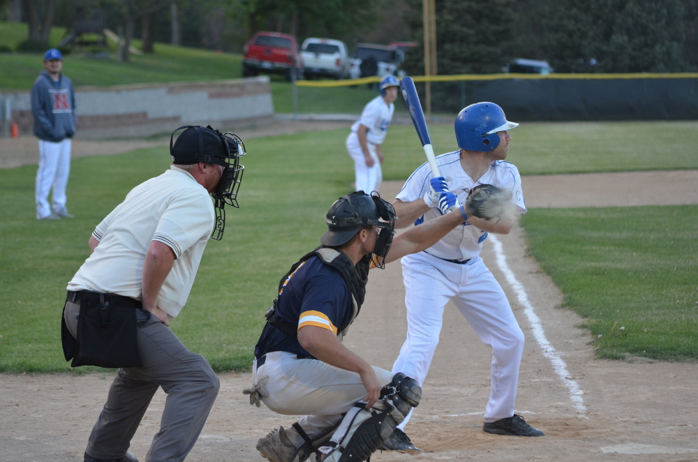 The dust flies from the catcher’s mitt as James Kaiser takes a ball at bat during last Thursday night’s home game against  the Tappers.