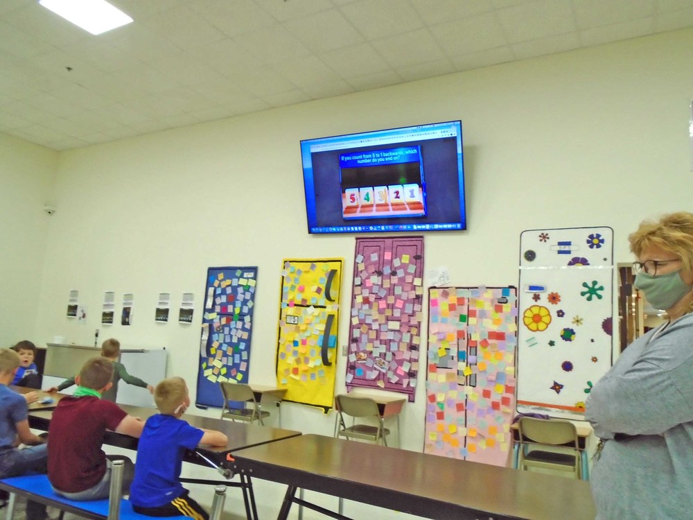 Bronco Academy students learn some of the lessons taught by watching a smart screen.