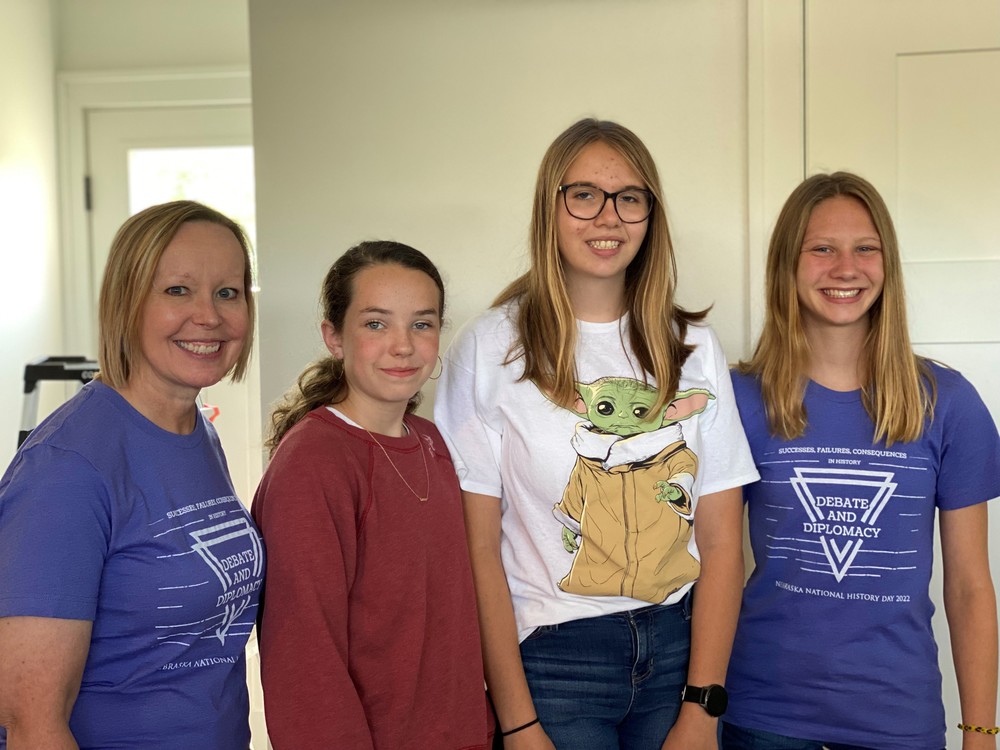 They are as follow in the photo: Mrs. Ginger Schieffer, Lauren Loecker, Katie Neuharth, Sophia Wortmann. All three girls will be freshmen at Crofton Community Schools in the fall. They started their National History Day project in October of 2021 and advanced from the local, regional, and state levels to participate in nationals.