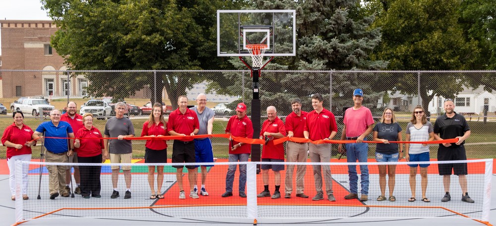 Pictured at the PBCF Ribbon Cutting of the new tennis courts in Chilvers Park were (l to r): Susan Norris, PBCF and PCED; Kent Warneke, Nebraska Community Foundation; Brook Curtiss; Corrine Janovec; Councilman Bob Smith; Kelly Lingenfelter; Kevin Lingenfelter; Mayor Brian Schlote; PBCF Co-Chairs Wayne Rasmussen and Jim Krause; Brian Ickler; Matt Meuret; Chad Korth of the LENRD; Amy Dummer and Lyn Stec from the Park Board; and City Administrator Jeremy Tarr.