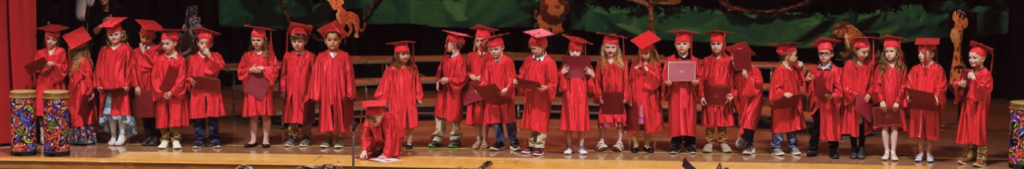 Kindergarten class graduates during music program...
