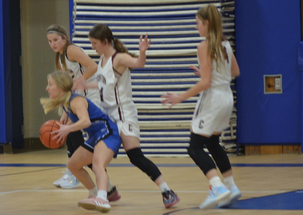 Sammie Allen (right), Ellie Tramp and Cassie Allen turn back a drive to the basket by HSF in the championship game last week.