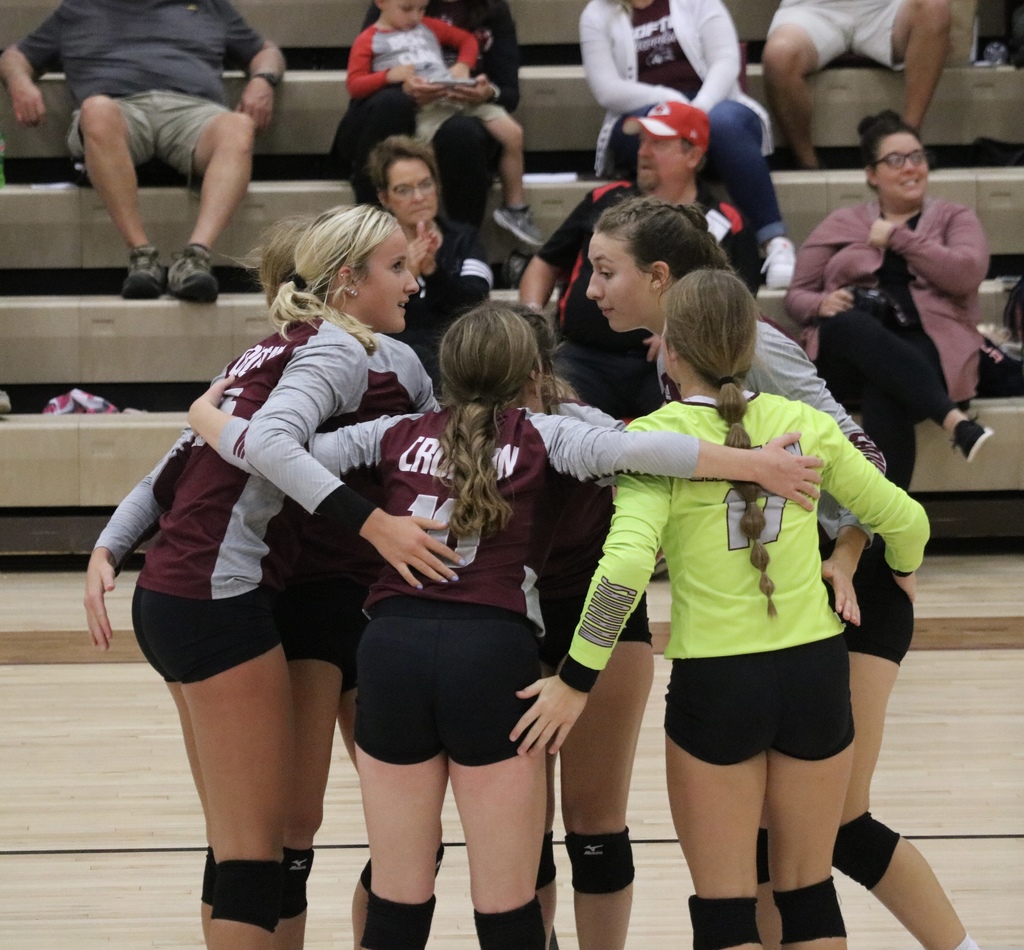 The Lady Warriors celebrating a point in their huddle.