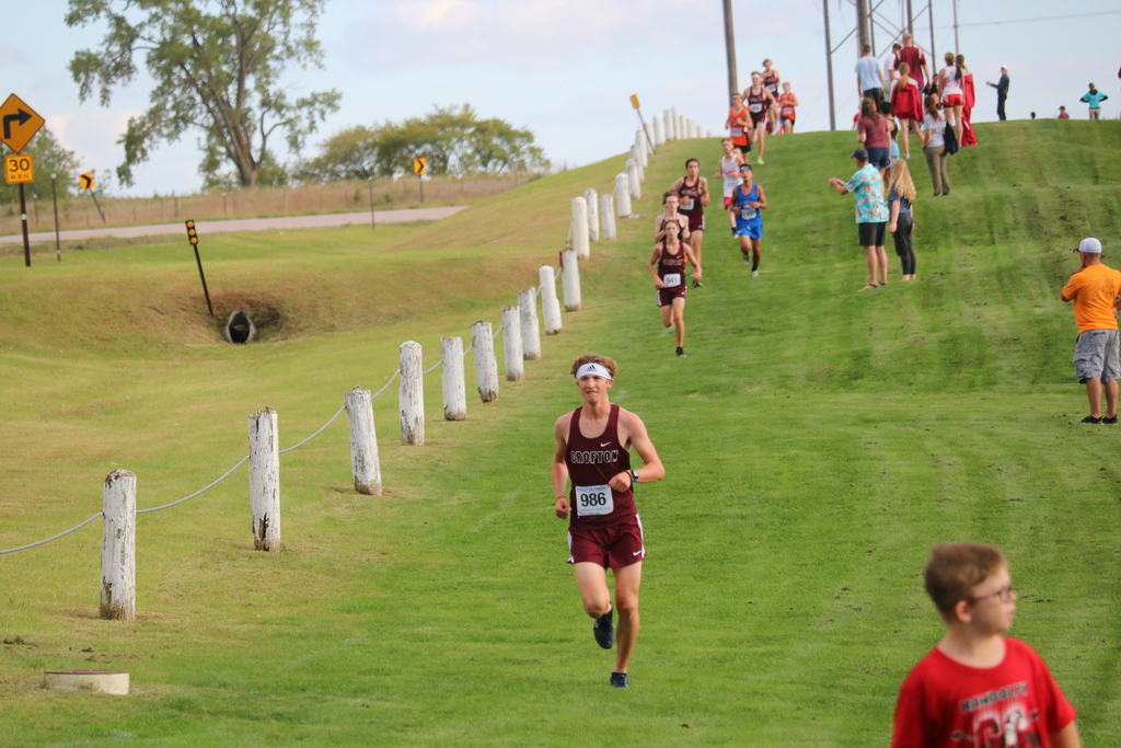 Senior Zac Arens pushes through the first mile of the boys race with sophomore Darin Babcock and senior Carter Guenther following behind him.