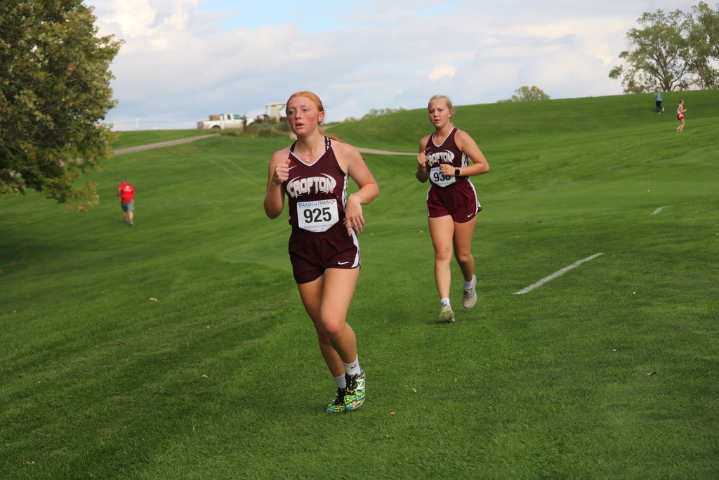 Sophomore Pamela Dennis and freshman Olivia Walter push each other in the girls race.
